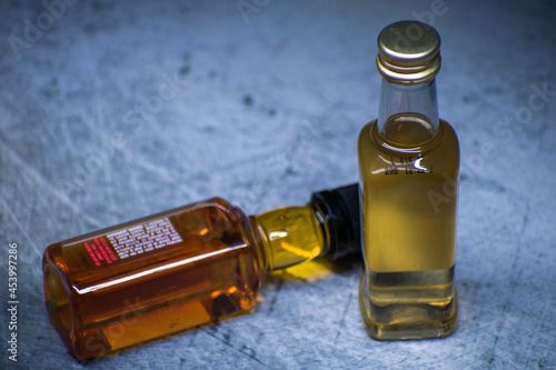 two bottles of liquor placed in a gray background