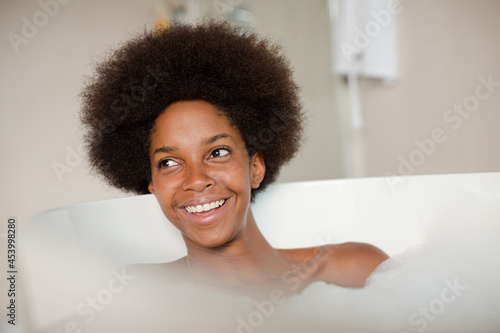 Woman playing with bubbles in bath