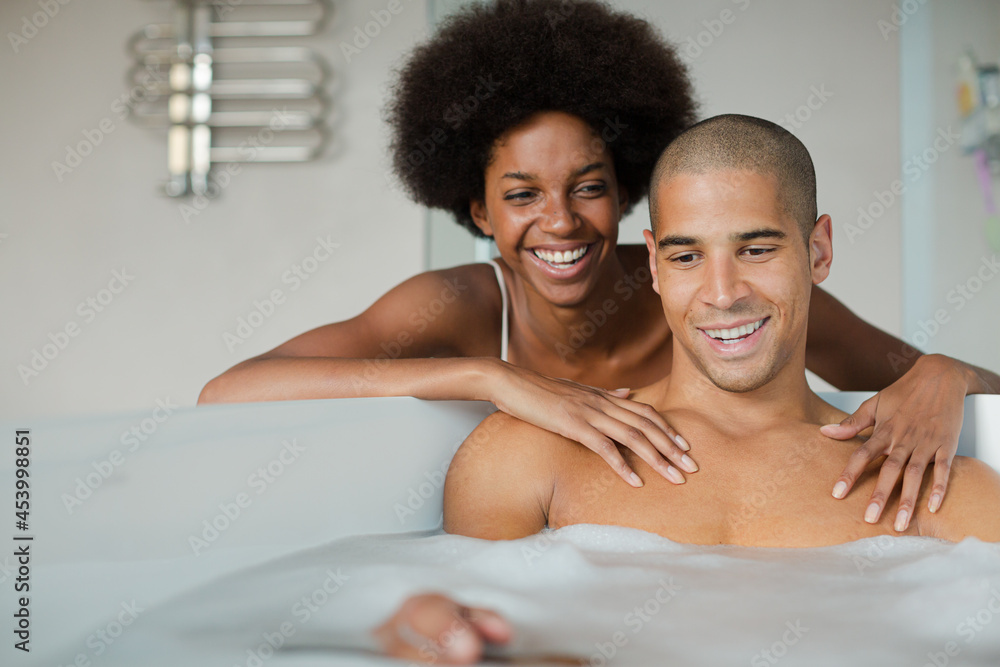 Woman playing with boyfriend in bubble bath Woman playing with boyfriend in bubble bath