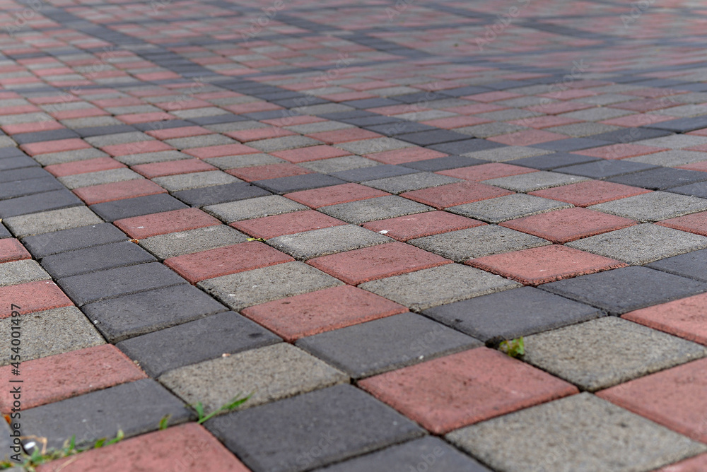 Fototapeta premium Paving stones. Concept of laying paving slabs and pavers. Paving stones. Concrete pavement blocks. can be used as background and wallpaper