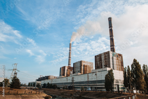 Air pollution, factory pipes, smoke from chimneys on sky background. Concept of industry, ecology, steam plant, heating season, global warming. Environmental Problem