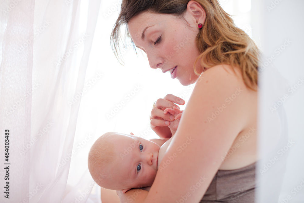Mother breast-feeding baby girl Mother breast-feeding baby girl