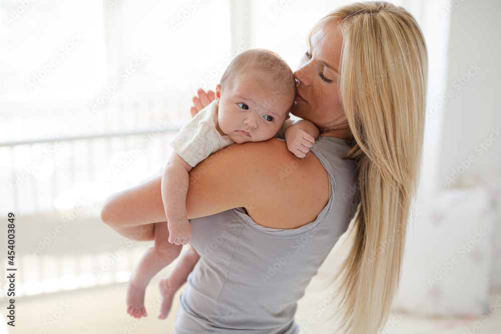 Mother holding baby girl in nursery Mother holding baby girl in nursery