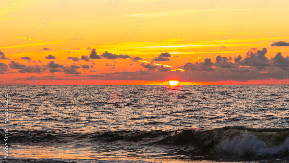 Beautiful sunset on the Baltic Sea, multi-colored colors, romantic mood, golden light reflections on the water,