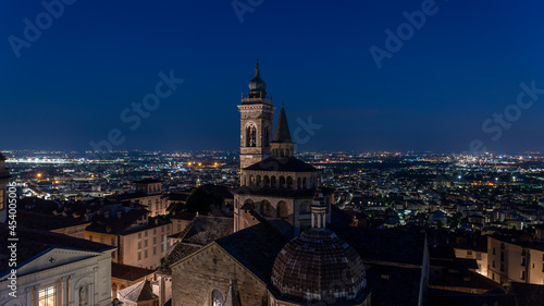 Bergamo, Italy. The old town. Amazing aerial view of the Basilica of Santa Maria Maggiore during the night. In the background the Po plain. Bergamo best of Italy