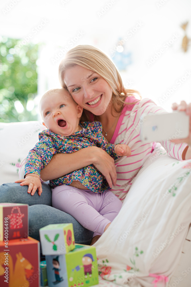 Mother taking self-portrait with baby girl Mother taking self-portrait with baby girl