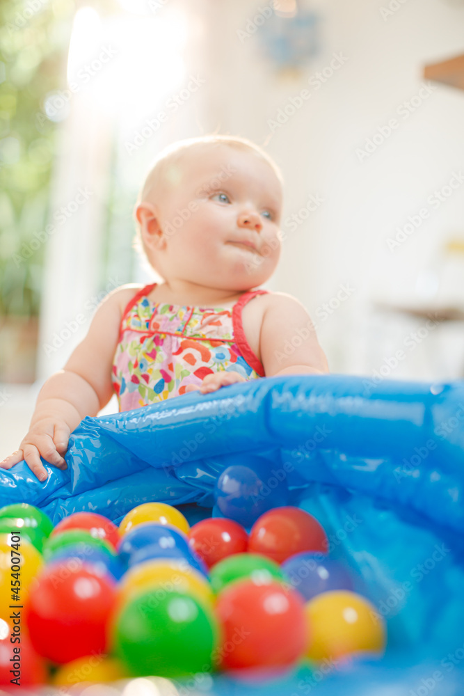 Baby girl playing with toys on floor Baby girl playing with toys on floor