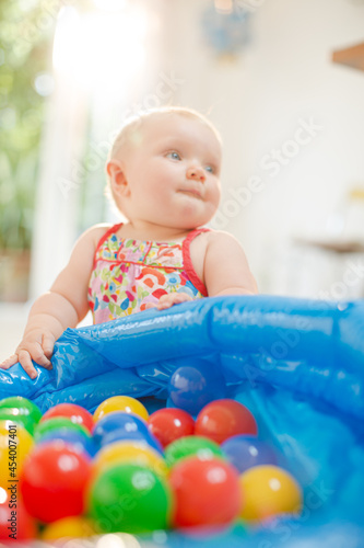 Baby girl playing with toys on floor