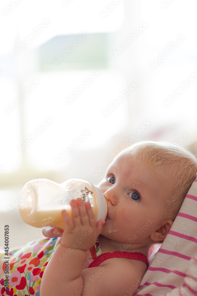 Baby girl drinking from bottle Baby girl drinking from bottle
