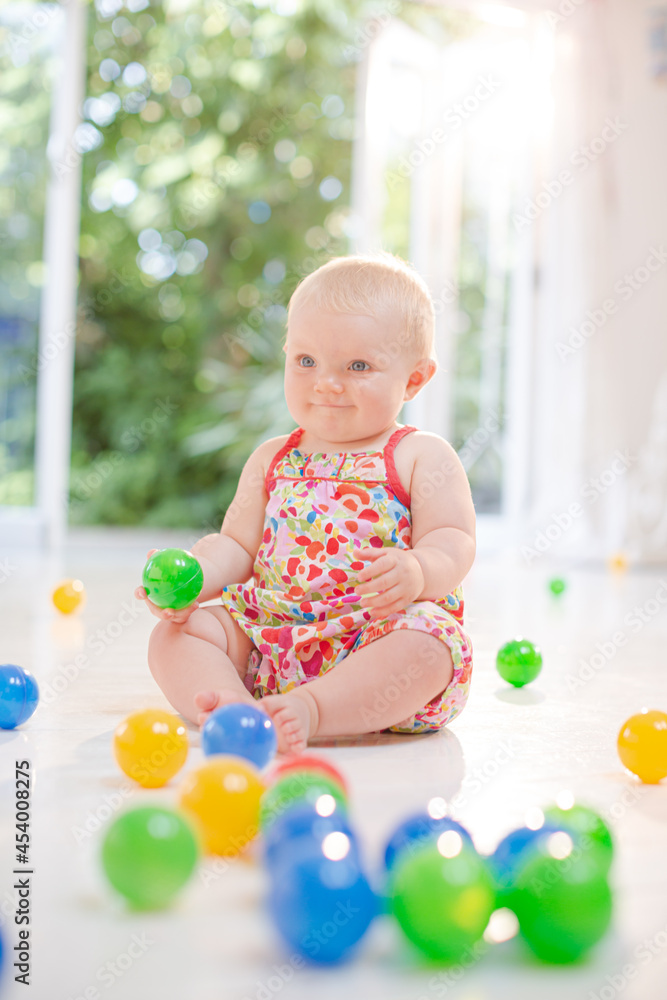 Baby girl playing with toys on floor Baby girl playing with toys on floor