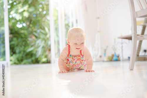 Baby girl crawling on floor