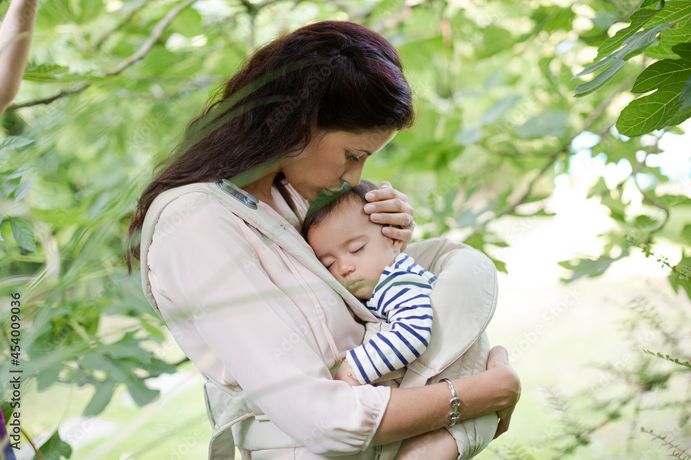 Mother holding baby boy outdoors