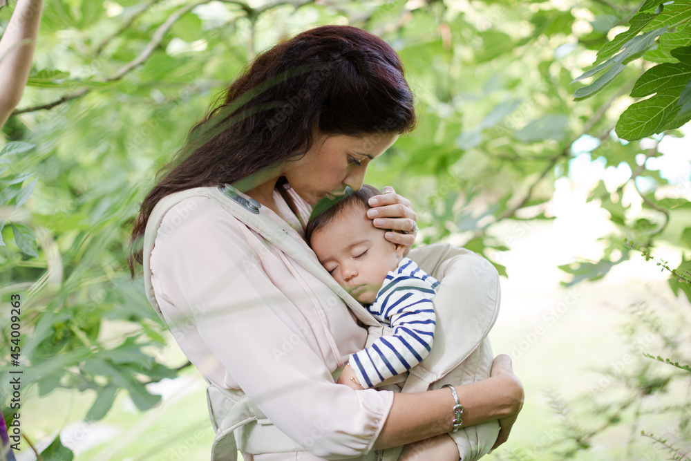 Mother holding baby boy outdoors