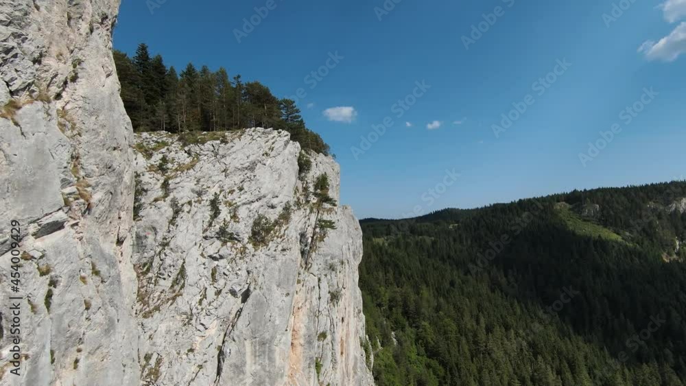 Aerial cinematic shot high speed sport fpv drone flying over natural mountain cliff surrounded Amazing nature rocky terrain with green vegetation. Aerial cinematic shot high speed sport fpv drone flying over natural mountain cliff surrounded Amazing nature rocky terrain with green vegetation.