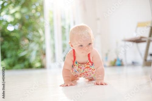 Baby girl crawling on floor