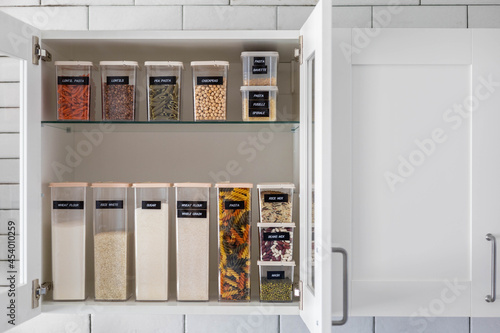 Kitchen storage organization use plastic case. Placing and sorting food products into pp box