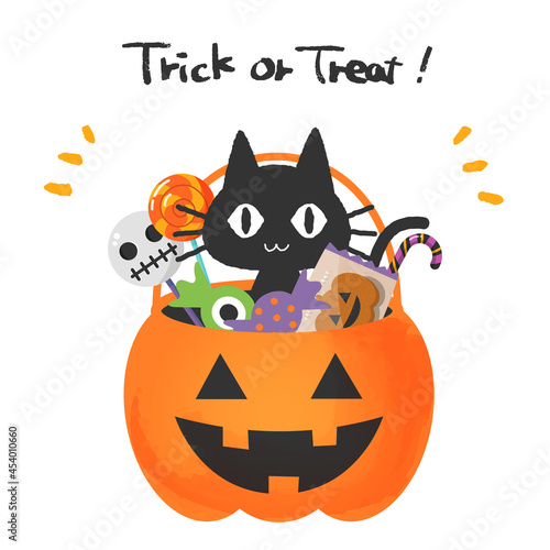 ハロウィンのカボチャのバスケットに入った黒猫とお菓子