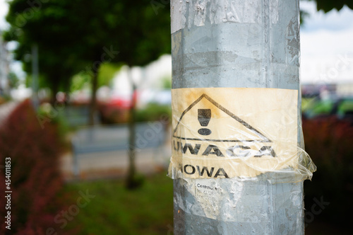 Shallow focus shot of a road warning sign on a metallic post in Poland photo