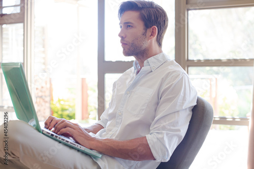 Tableau sur toile Man using laptop in living room