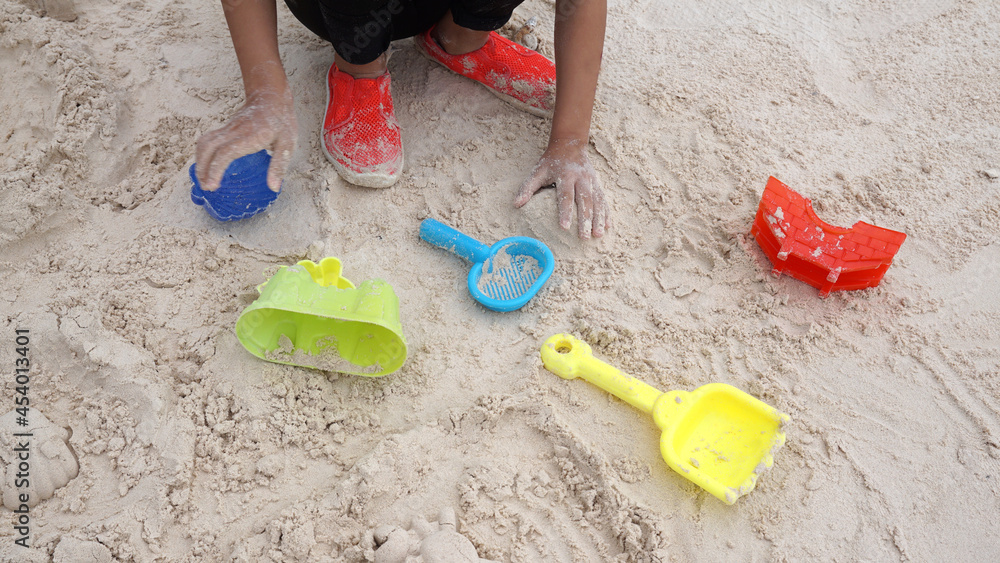 Kid hands with colorful toy on the beach Kid hands with colorful toy on the beach