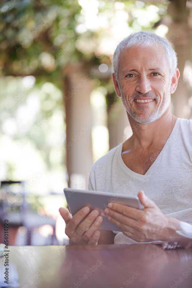 Man using digital tablet at table Man using digital tablet at table