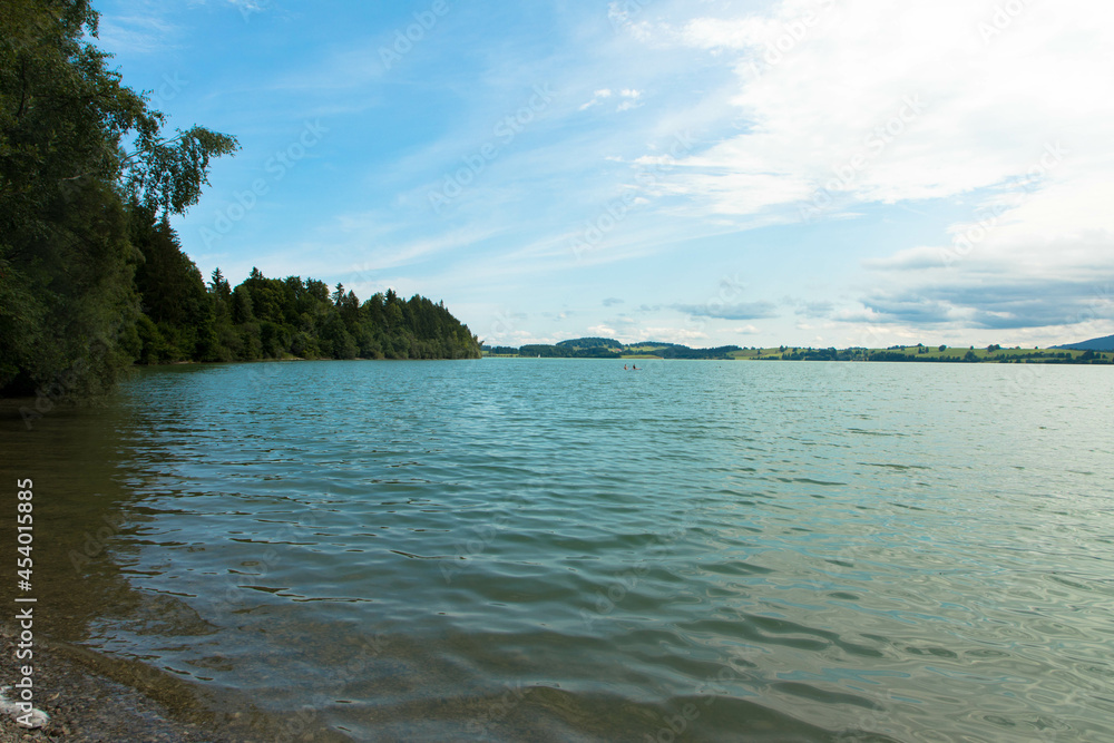 The Forggensee Lake, also known as the Roßhaupten reservoir, near Füssen. Panorama view. The Forggensee Lake, also known as the Roßhaupten reservoir, near Füssen. Panorama view.