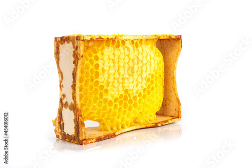 Frame with full honeycombs of honey, isolated on glossy background © lisssbetha