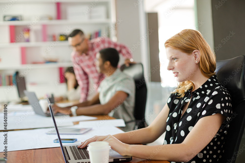 Woman working at laptop in office