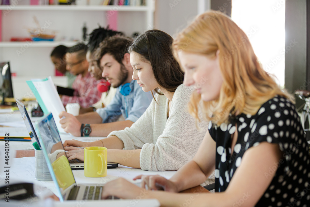 People working at conference table in office People working at conference table in office