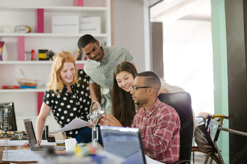 People examining model in office People examining model in office