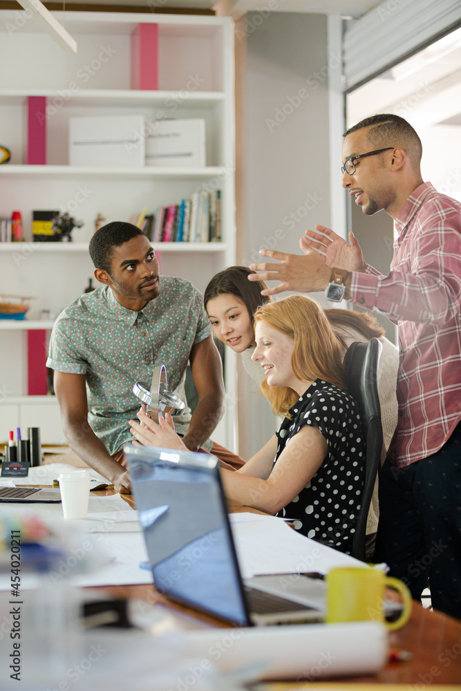 People examining model in office People examining model in office