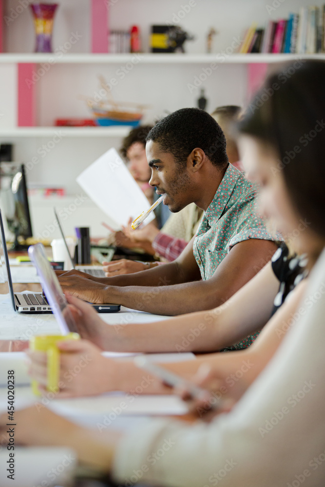 People working at conference table in office People working at conference table in office