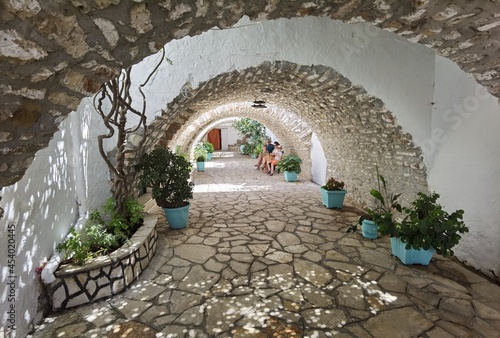 palaiokastritsa monasteri in corfu island greece sea yard people in summer holidays