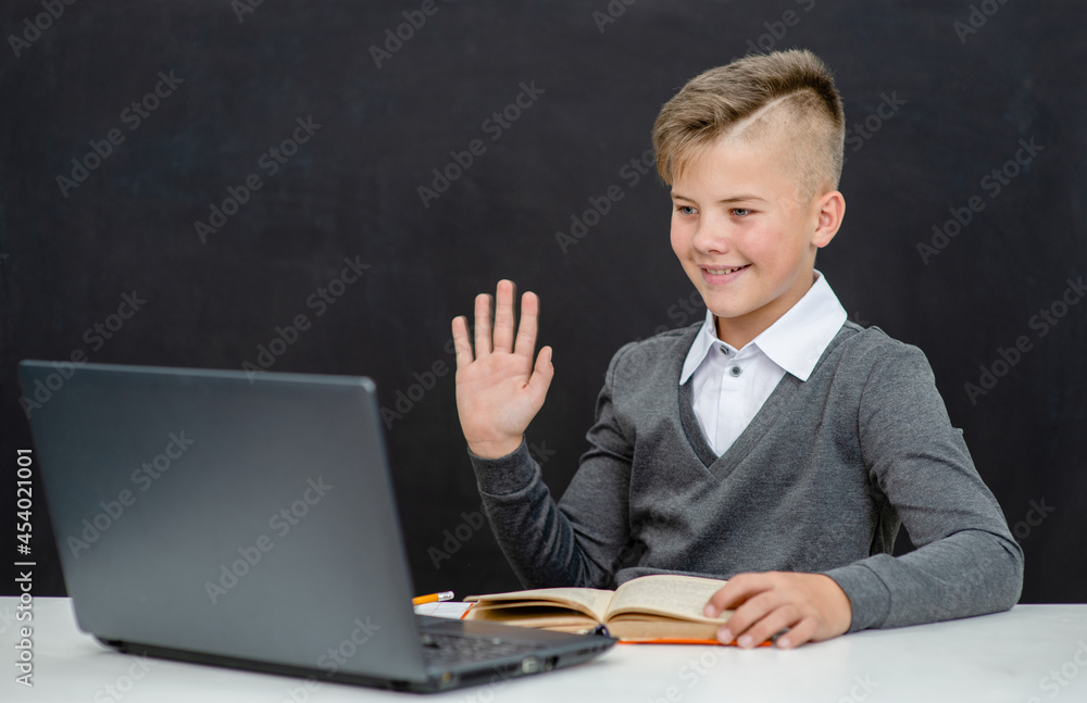Teen boy uses laptop for education. Distance education concept Teen boy uses laptop for education. Distance education concept