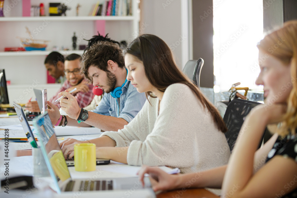 People working at conference table in office People working at conference table in office