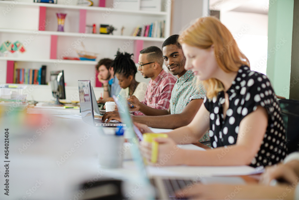 People working at conference table in office People working at conference table in office