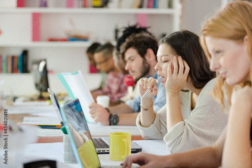 People working at conference table in office People working at conference table in office