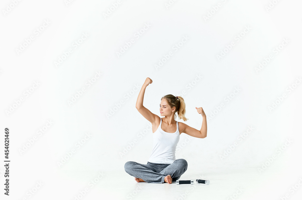 woman sitting on the floor with dumbbells exercise health motivation woman sitting on the floor with dumbbells exercise health motivation