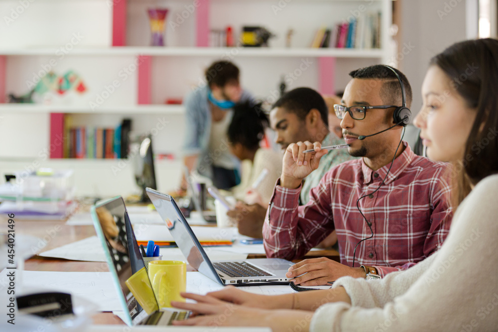 People working at conference table in office People working at conference table in office