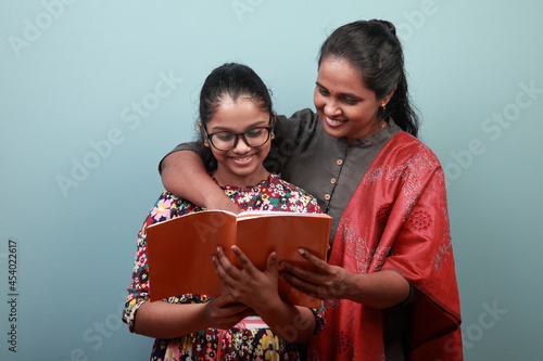 Indian ethnic mother helps daughter in her studies photo