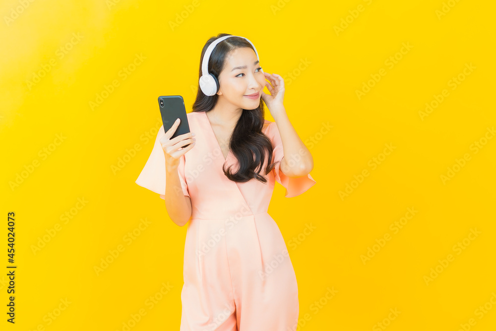 Portrait beautiful young asian woman with headphone and smart phone for listen music Portrait beautiful young asian woman with headphone and smart phone for listen music