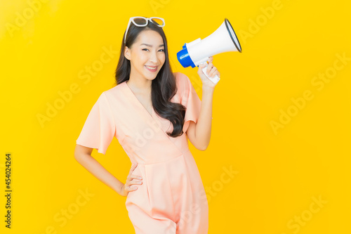 Portrait beautiful young asian woman smile with megaphone