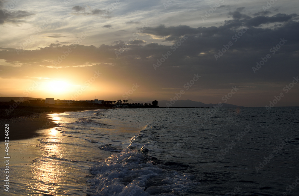 Sunset and waves on sea near Heraklion, Crete