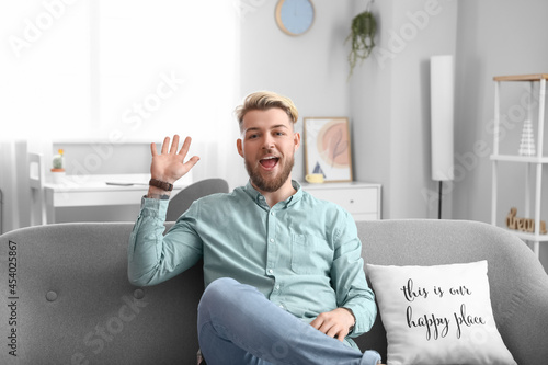 Young man video chatting at...