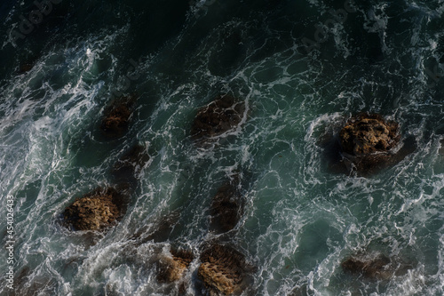 Ocean wave background breaking sea water rocky shore © YURII Seleznov
