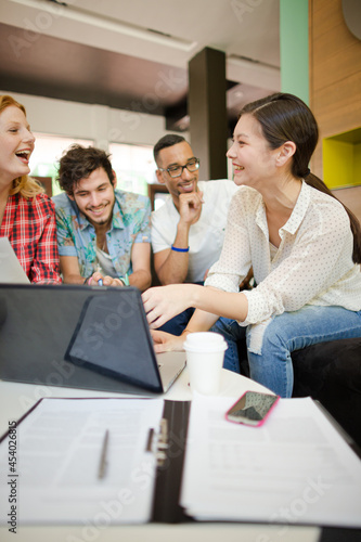 People working at laptop in office