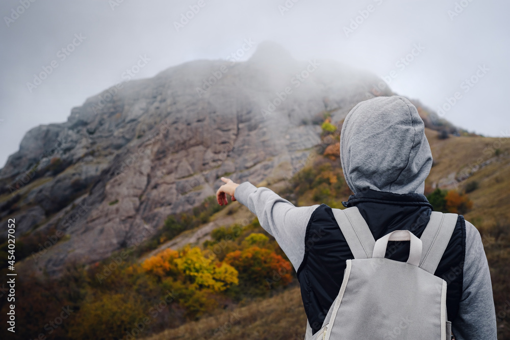 Asian woman stands by the mountain. Cold weather Asian woman stands by the mountain. Cold weather