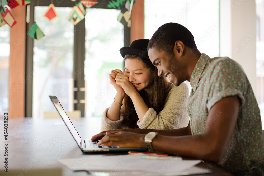 People working together on laptop in office