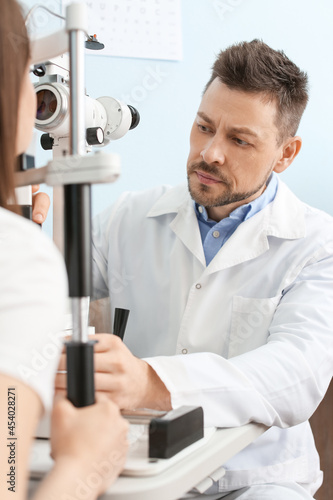 Ophthalmologist examining w...