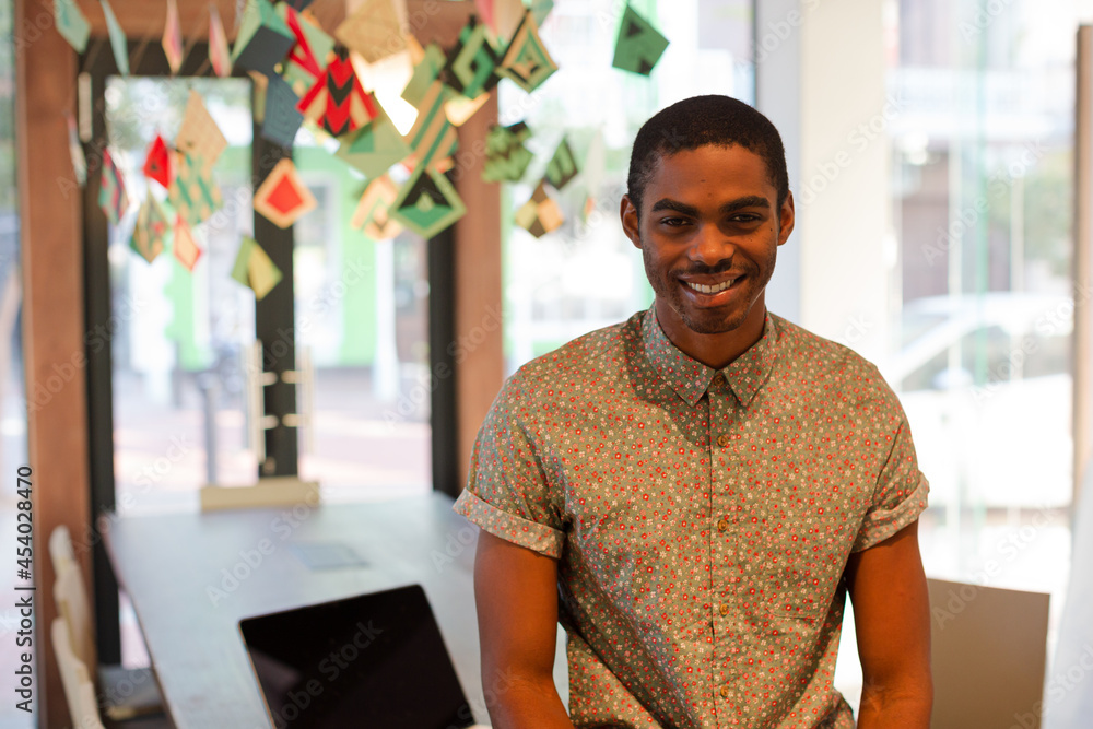 Man leaning on desk in office